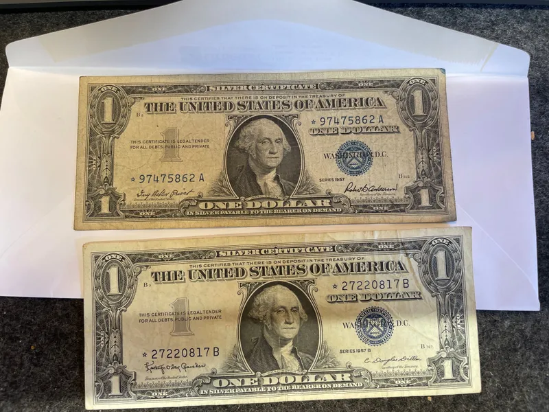 Lot Of 2 - 1957 $1 STAR Note Silver Certificate Blue Seal U.S. One Dollar Bills
CONDITION IS FAIR .... THEY HAVE BEEN KEPT PRESSED IN A BOOK 30 YEARS from auction in Brewton, Alabama