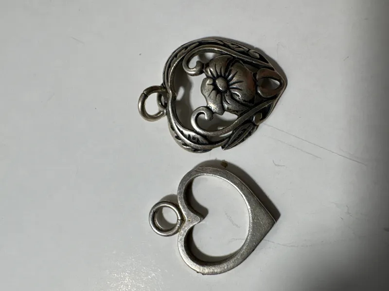Two Sterling Silver Heart Pendants Including Silpada Floral Design from auction in Brewton, Alabama