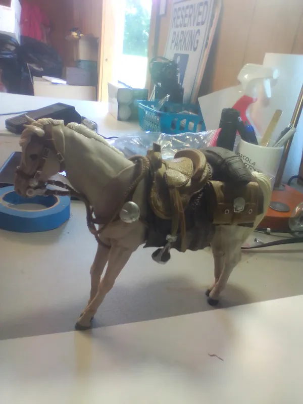 Articulated Model Horse with Western Style Tack and Skull Emblem Saddlebags from auction in Brewton, Alabama