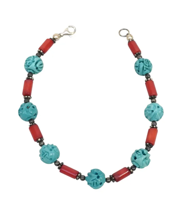 CARVED HOWLITE & CORAL BRACELET. from auction in Mount Pleasant, South Carolina