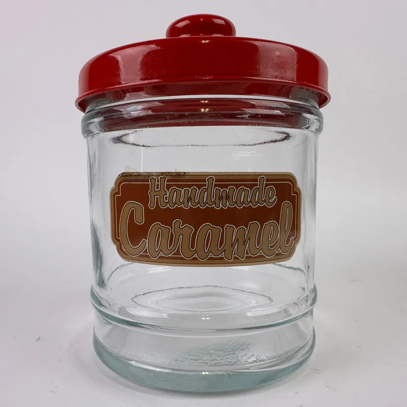 Vintage Style Glass Handmade Caramel Countertop Candy Jar with Red Lid from auction in Orlando, Florida