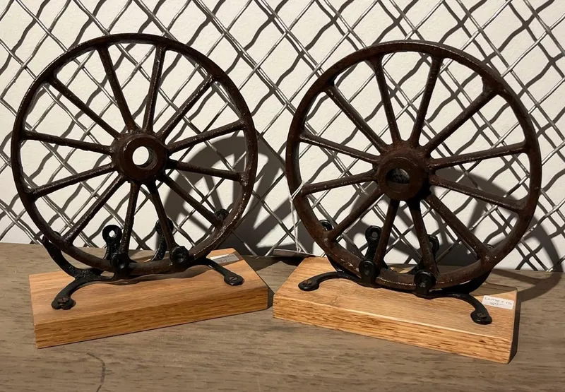 Pair Cast Iron Wheel Bookends on Oak from auction in Dundee, Ohio