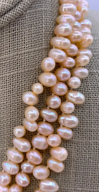 Luminous Triple Strand Blushing Apricot Teardrop Baroque Freshwater Pearl Necklace from auction in Dundee, Ohio