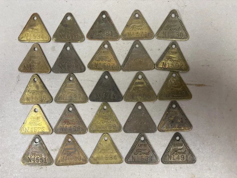 Lot 25 Ford Motor Company Rouge River Plant Tags from auction in Jackson, Michigan