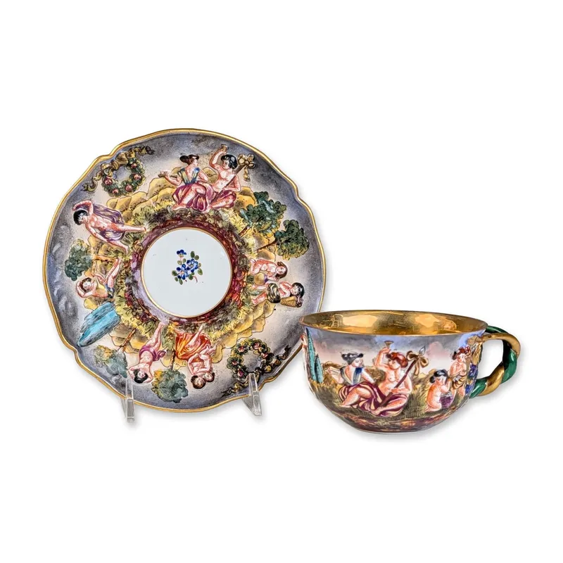 2pc Capodimonte Italian Relief Molded Porcelain Mythological Cup and Saucer Set from auction in Hollywood, Florida