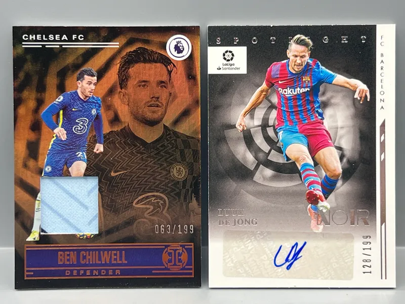 2021-22 Panini Chronicles Illusions Premier League Ben Chilwell Relic #/199 & 2021-22 Panini Chronicles Noir La Liga Luuk De Jong Auto #/199 from auction in Greenville, Ohio