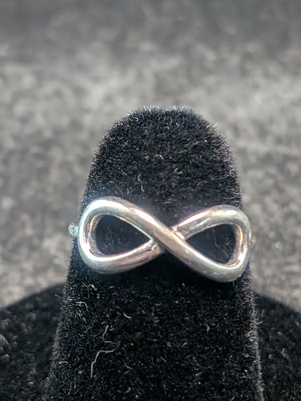 Woman's Sterling Silver Infinity Symbol Design, Size 5 Ring, Marked CIJ China 925.Ring Weighs 0.05 Troy oz. (1.7 Grams). from auction in Greenville, Ohio
