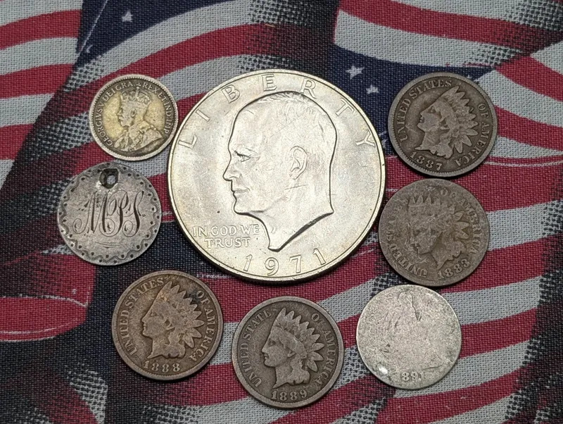 1883, 1887, 1888, 1889 Indian Head Cents, 1891 Seated Liberty Dime, No Date Seated Liberty Love Token, 1971 Eisenhower Dollar, & 1913 Canada 5 Cents from auction in Greenville, Ohio