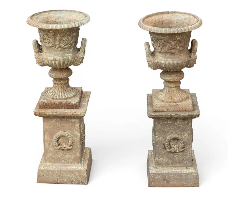 Pair of Cast Iron Urns on Bases from auction in York, Pennsylvania