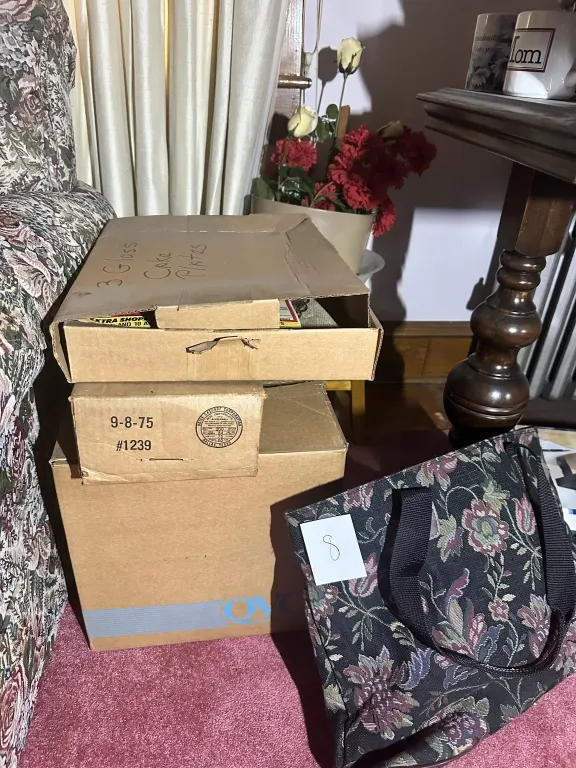 Box Lot Of Glass Plates & Silverplate estate box lot with glass cake plates, trays, candlestick, and assorted serving pieces. from auction in Clifford , Pennsylvania