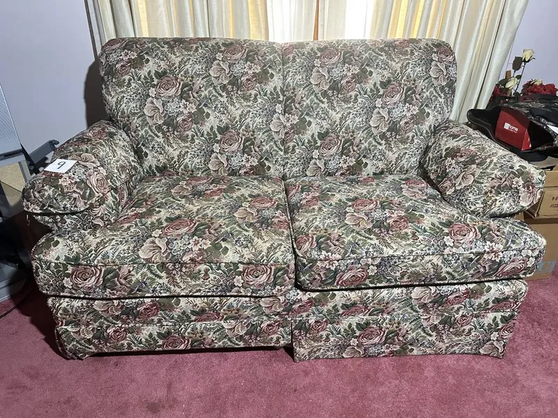 Floral Upholstered Loveseat 2-cushion floral upholstered loveseat. Measures approx. 63" long from auction in Clifford , Pennsylvania