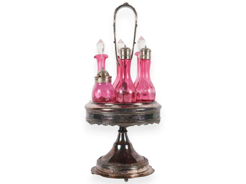 A Set of Five Victorian Cranberry Glass Bottles in an Ornate Silver-Plated Caster Stand from auction in Atlanta, Georgia