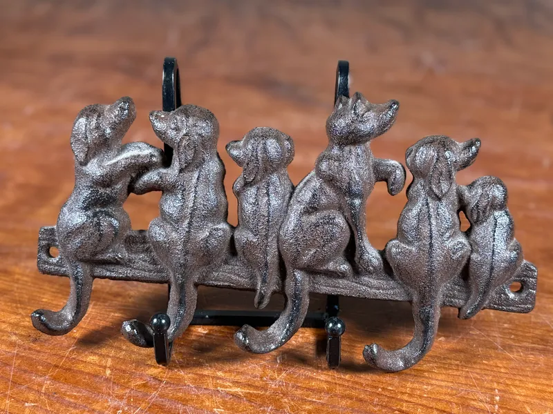 CAST IRON "DOG FAMILY" WALL HOOK RACK from auction in Salem, Oregon