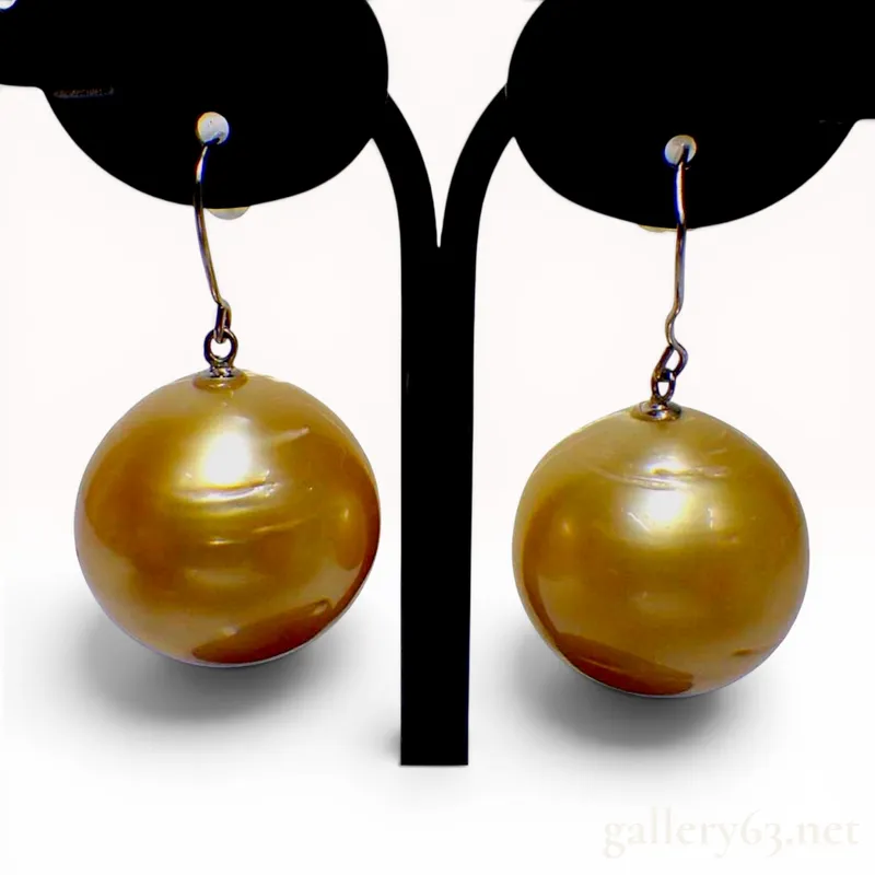 A Pair of Semi-Round Golden Pearl and Pt900 Platinum Earrings from auction in Atlanta, Georgia