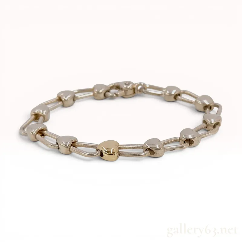 Tiffany and Co. Sterling Silver and 18 Karat Yellow Gold Heart Link Bracelet from auction in Atlanta, Georgia