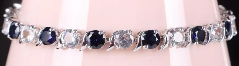 13.5CT SAPPHIRE & WHITE TOPAZ TENNIS BRACELET from auction in Tallahassee, Florida