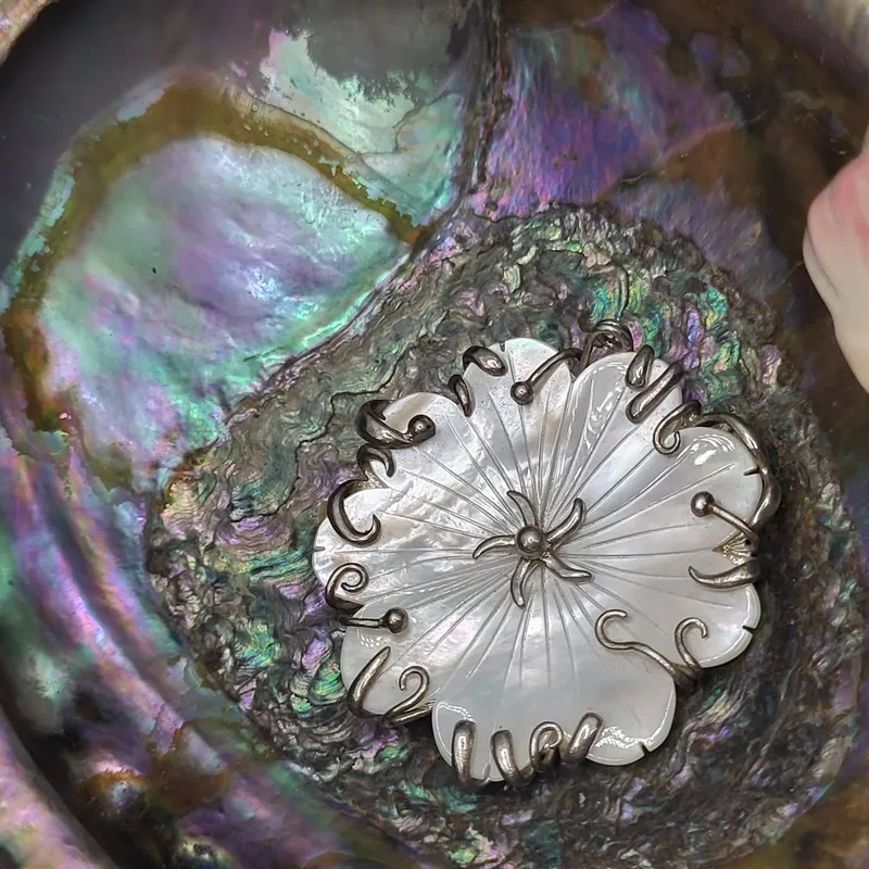 Carved Mother of Pearl Flower and Tendrils Pendant from auction in Vero Beach, Florida