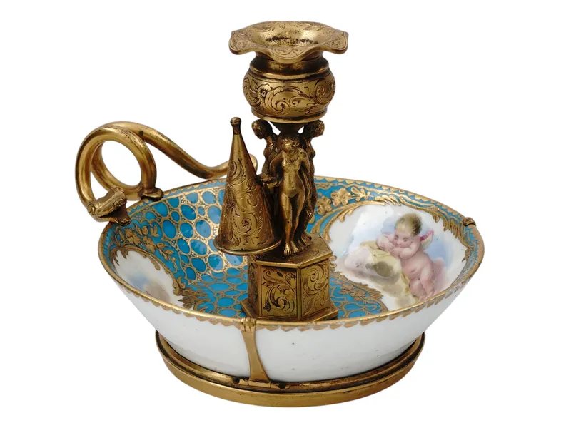A VIENNA GILT PORCELAIN FIGURAL CHAMBERSTICK, 19TH CEN. from auction in New York, New York