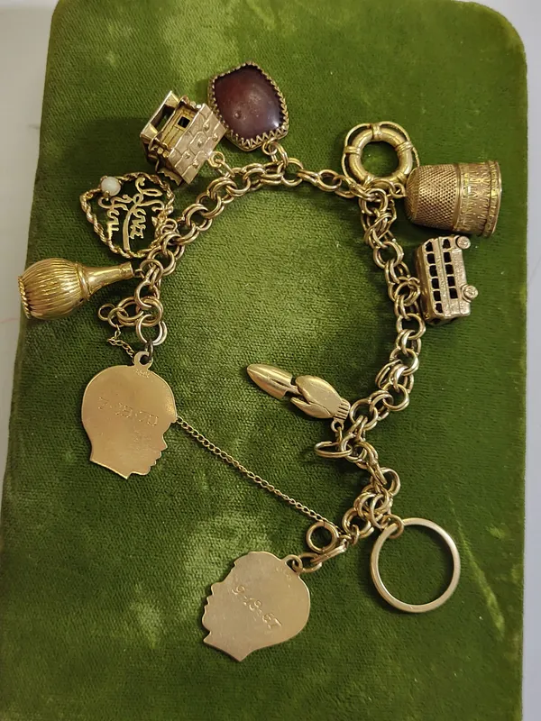 14K yellow gold charm bracelet, log cabin, thimble from auction in wilmington , North Carolina