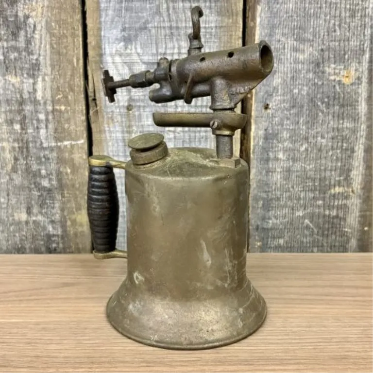 Antique Brass Gasoline Blowtorch with Cast Iron Burner and Ribbed Wood Handle from auction in Shelbyville, Kentucky