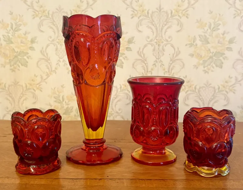 A Collection of Amberina Moon and Star Pattern Pressed Glass Tableware from auction in Shelbyville, Kentucky