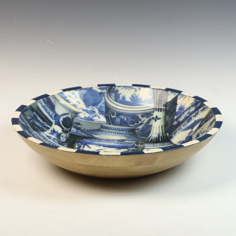 Large Annie Modica Decoupage Wood Bowl with Blue and White Porcelain Design from auction in Morgantown, Pennsylvania