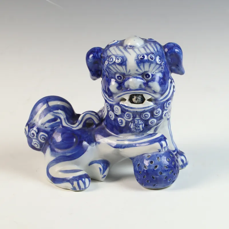 Blue and White Porcelain Guardian Lion Figurine with Brocade Ball and Cub from auction in Morgantown, Pennsylvania