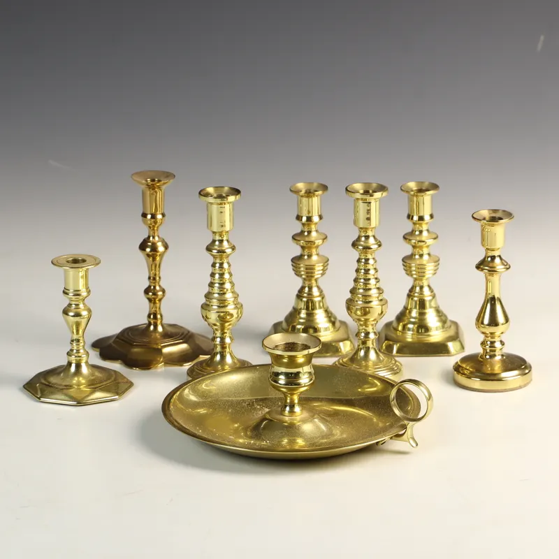 An Assortment of Eight Baldwin and Historic Charleston Polished Brass Candlesticks and a Chamberstick from auction in Morgantown, Pennsylvania