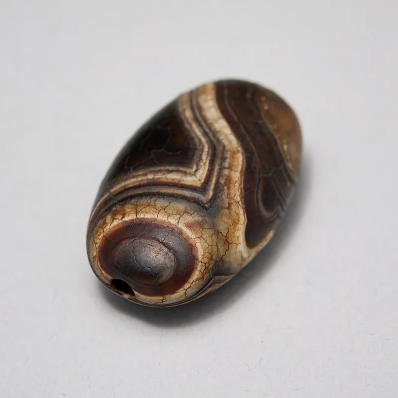 Himalayan Sulemani Agate Flattened Barrel Dzi Bead from auction in St. Paul, Minnesota